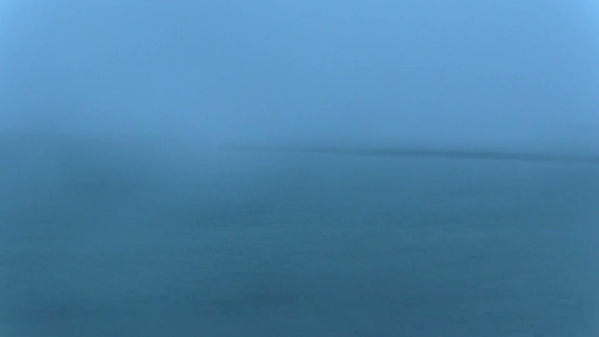 A hazy, indistinct view of a body of water on a foggy day.