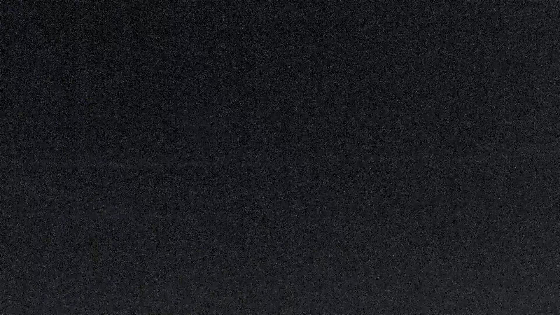 A dark gray, textured surface fills the entire image.