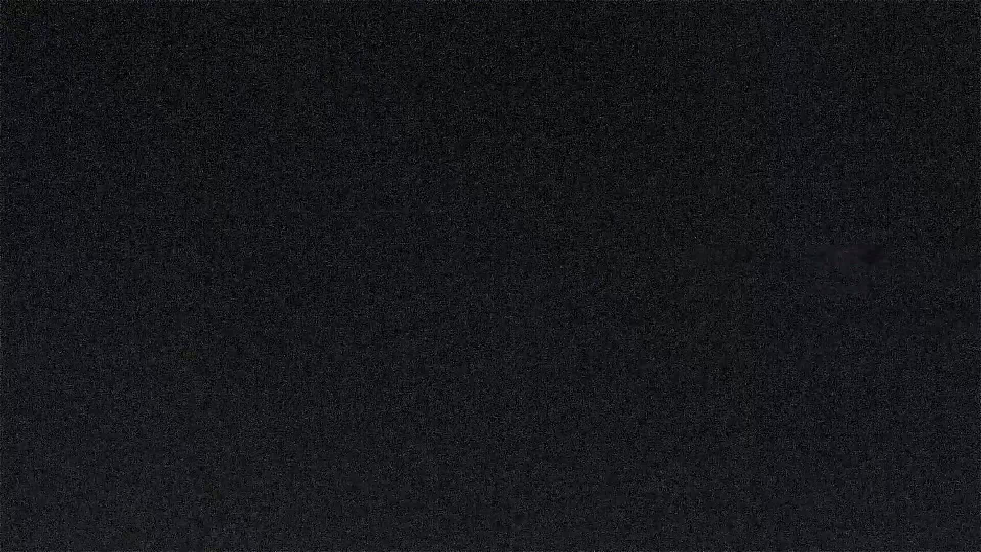 The image shows a uniformly dark-grey or black textured surface.