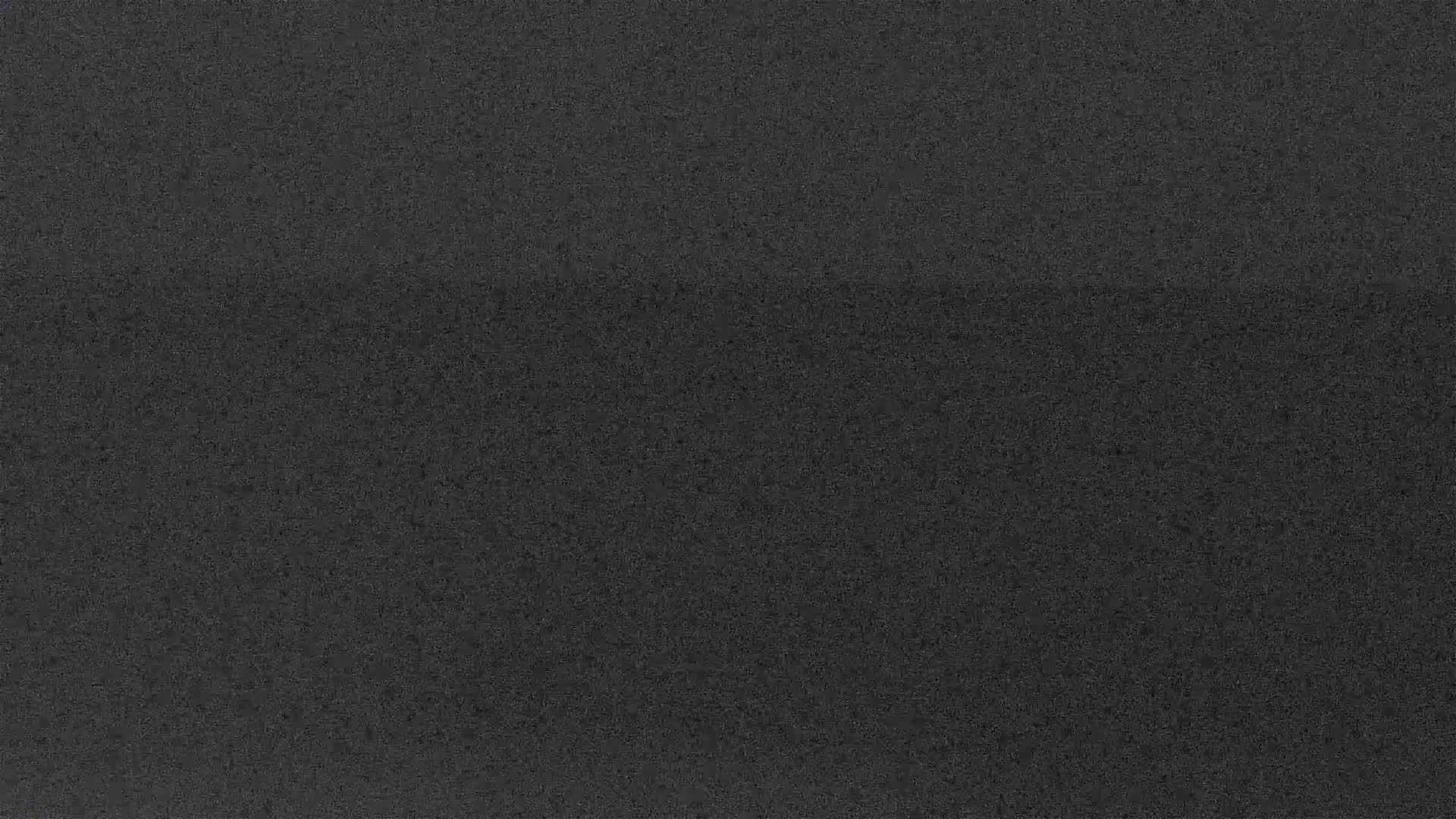 The image shows a dark gray textured surface.