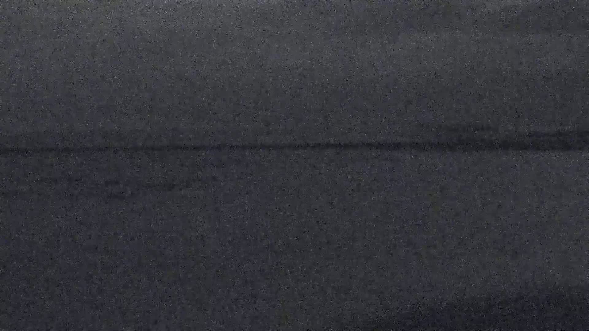 A dark gray textured surface shows a faint horizontal line across the middle.