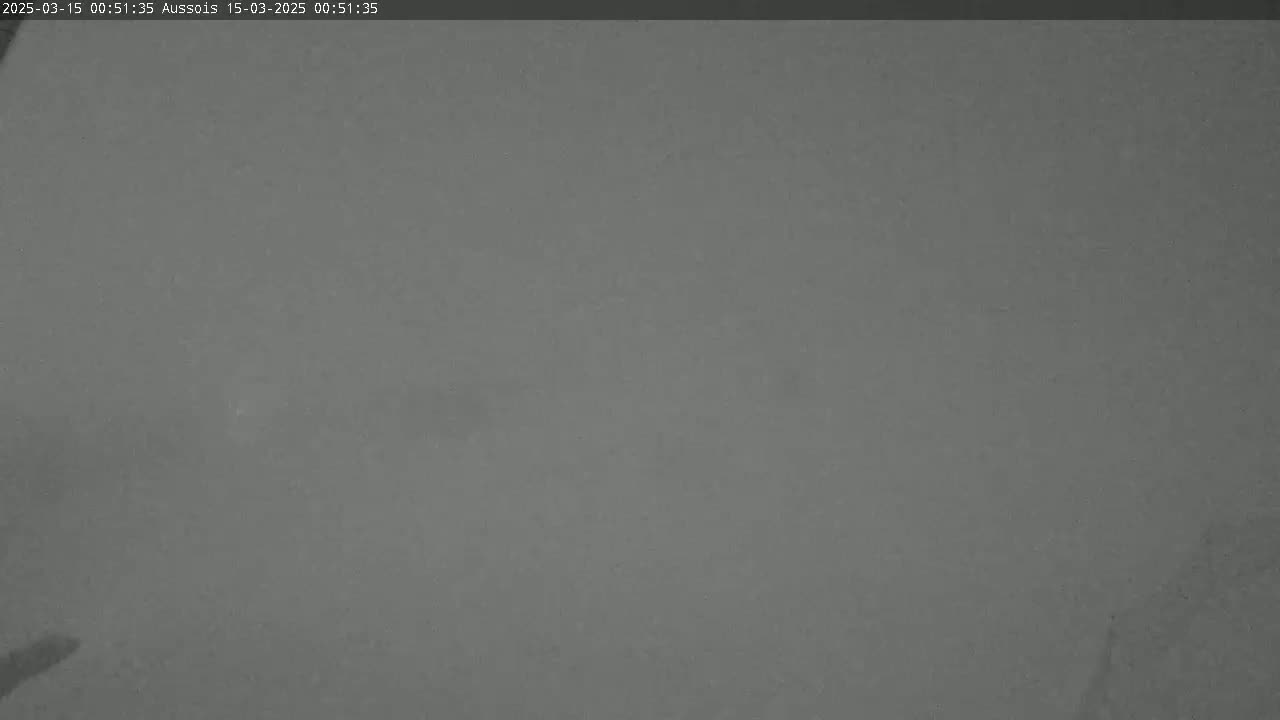A mostly featureless, dark gray image shows a foggy or hazy outdoor scene.