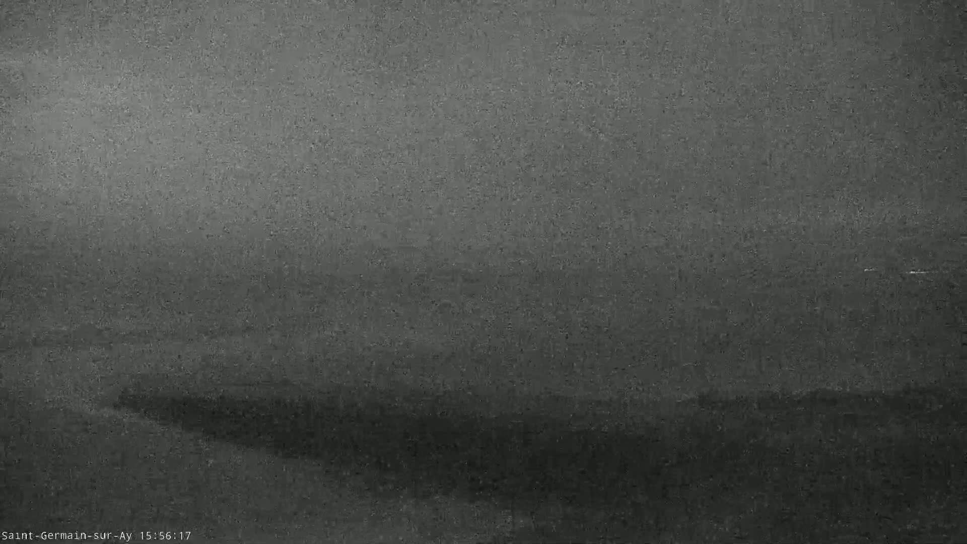 A low-visibility, hazy landscape is shown, possibly due to fog or mist.