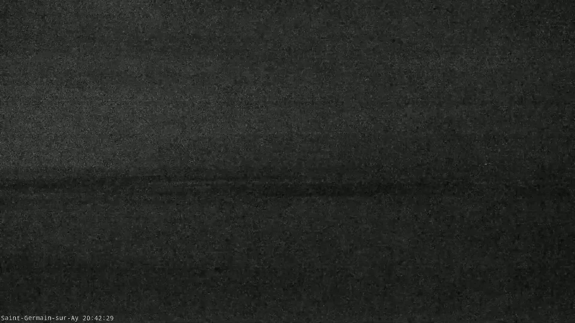 A dark gray, grainy image shows a blurry, indistinct horizontal line across the center.