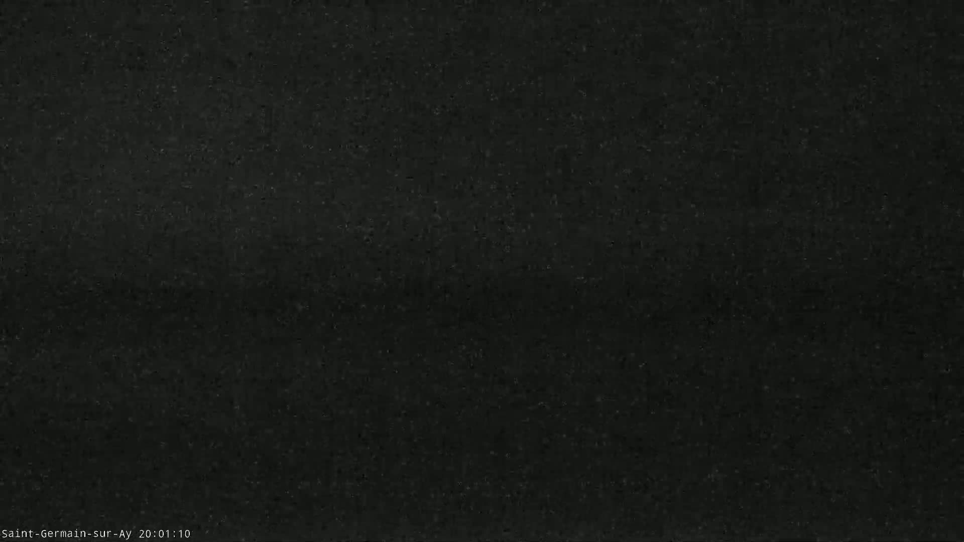 A dark, grainy image shows a uniformly colored, possibly asphalt surface.