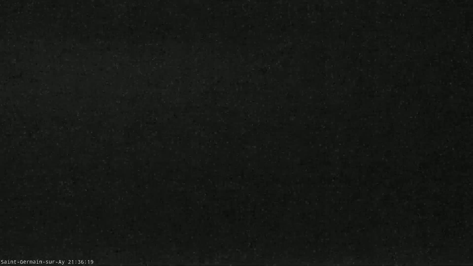 The image shows a dark, grainy surface.