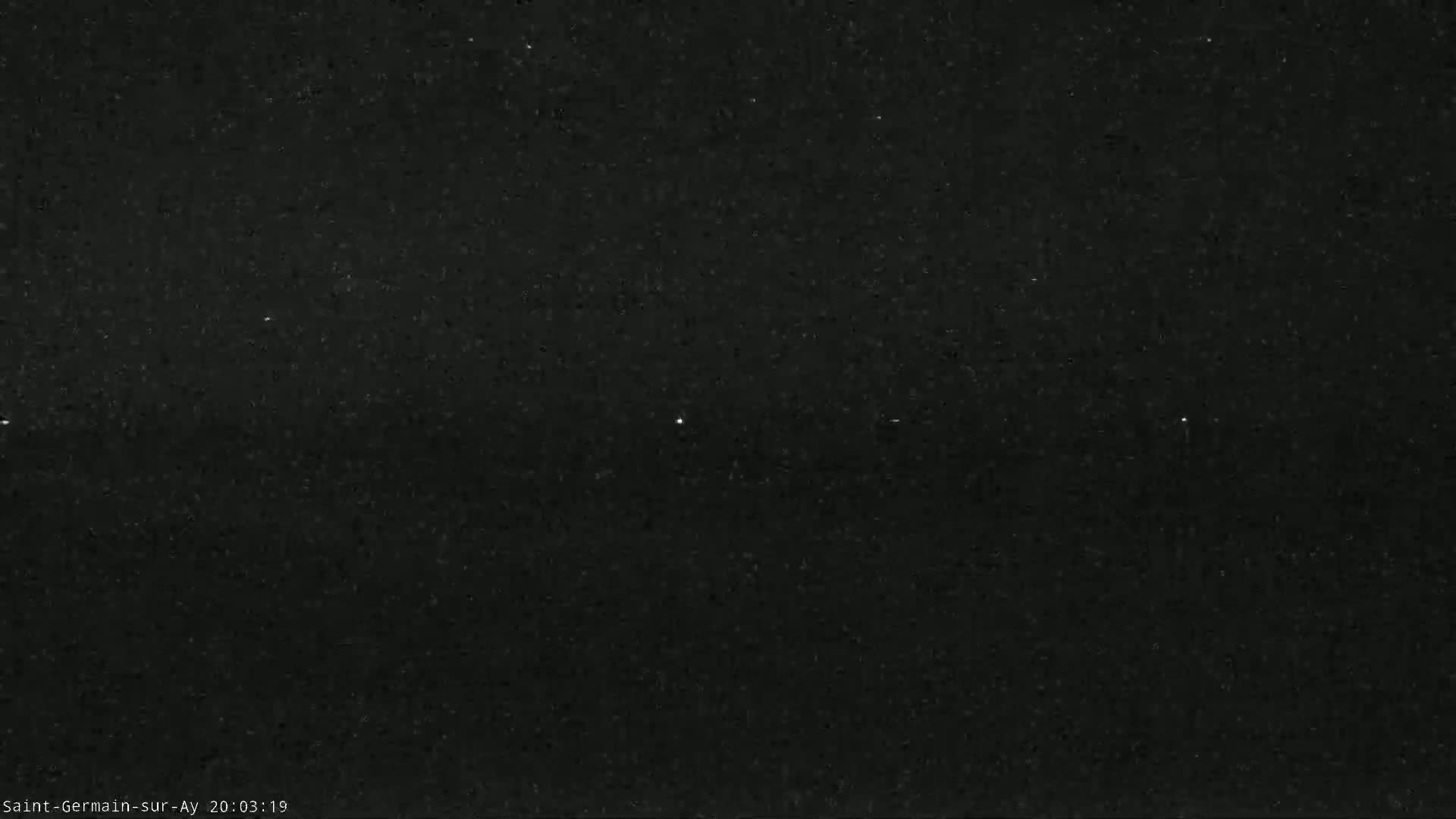 A nighttime image shows a dark sky speckled with stars.