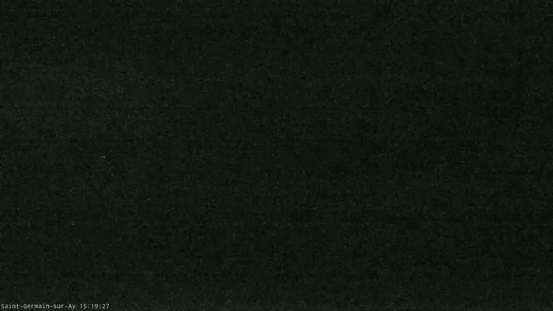 The image shows a dark, textured surface that appears to be a dark-colored material.