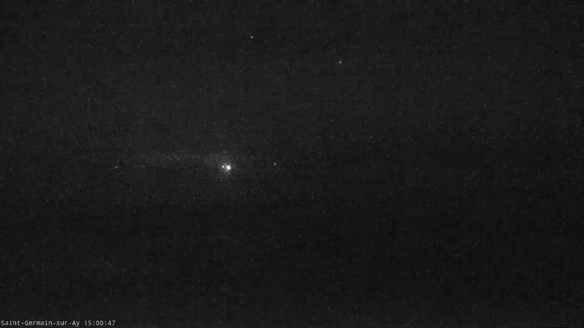 A nighttime image shows a dark sky with a bright star and several fainter stars visible.