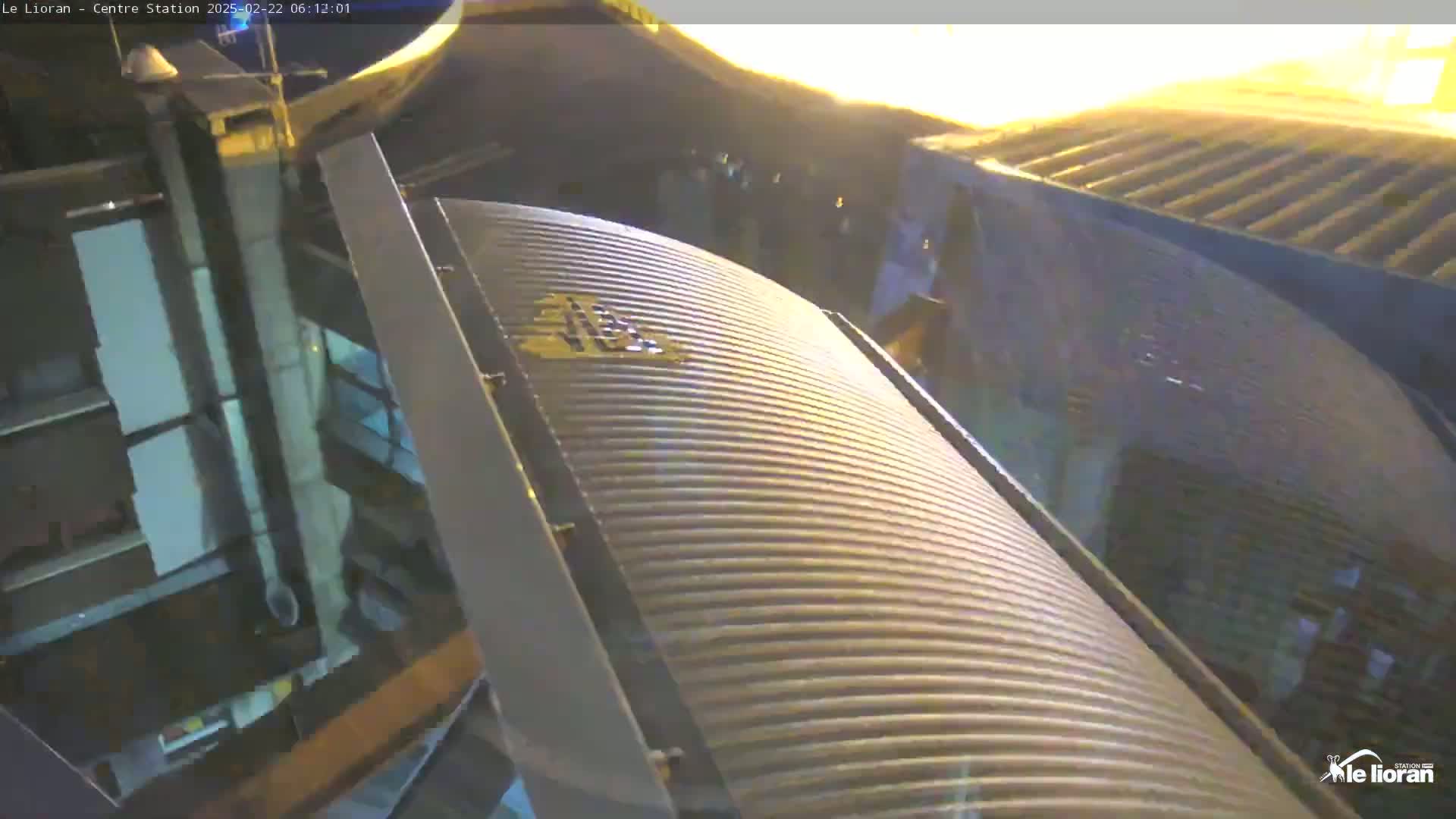 A close-up view of a curved, ribbed metal structure at night.