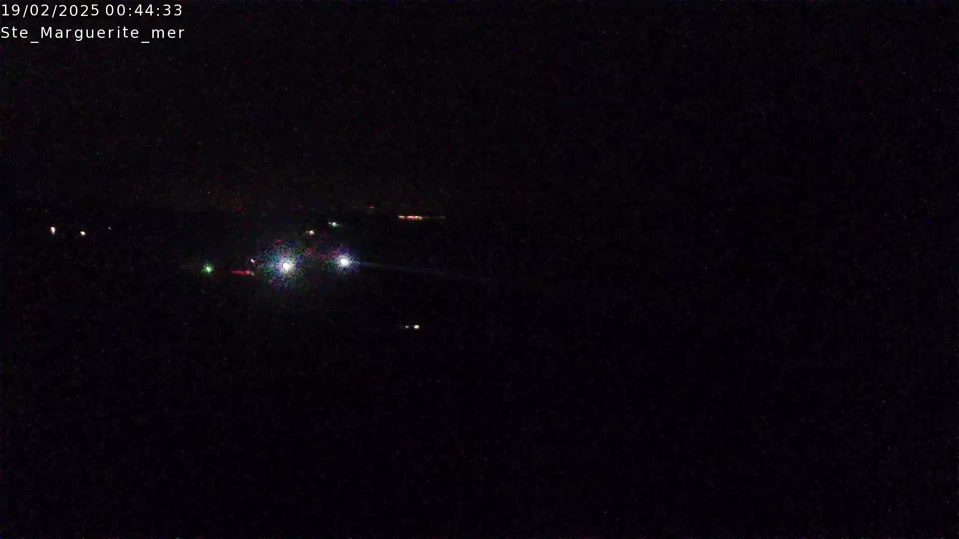 Faint lights from distant vehicles are visible in the dark of night.