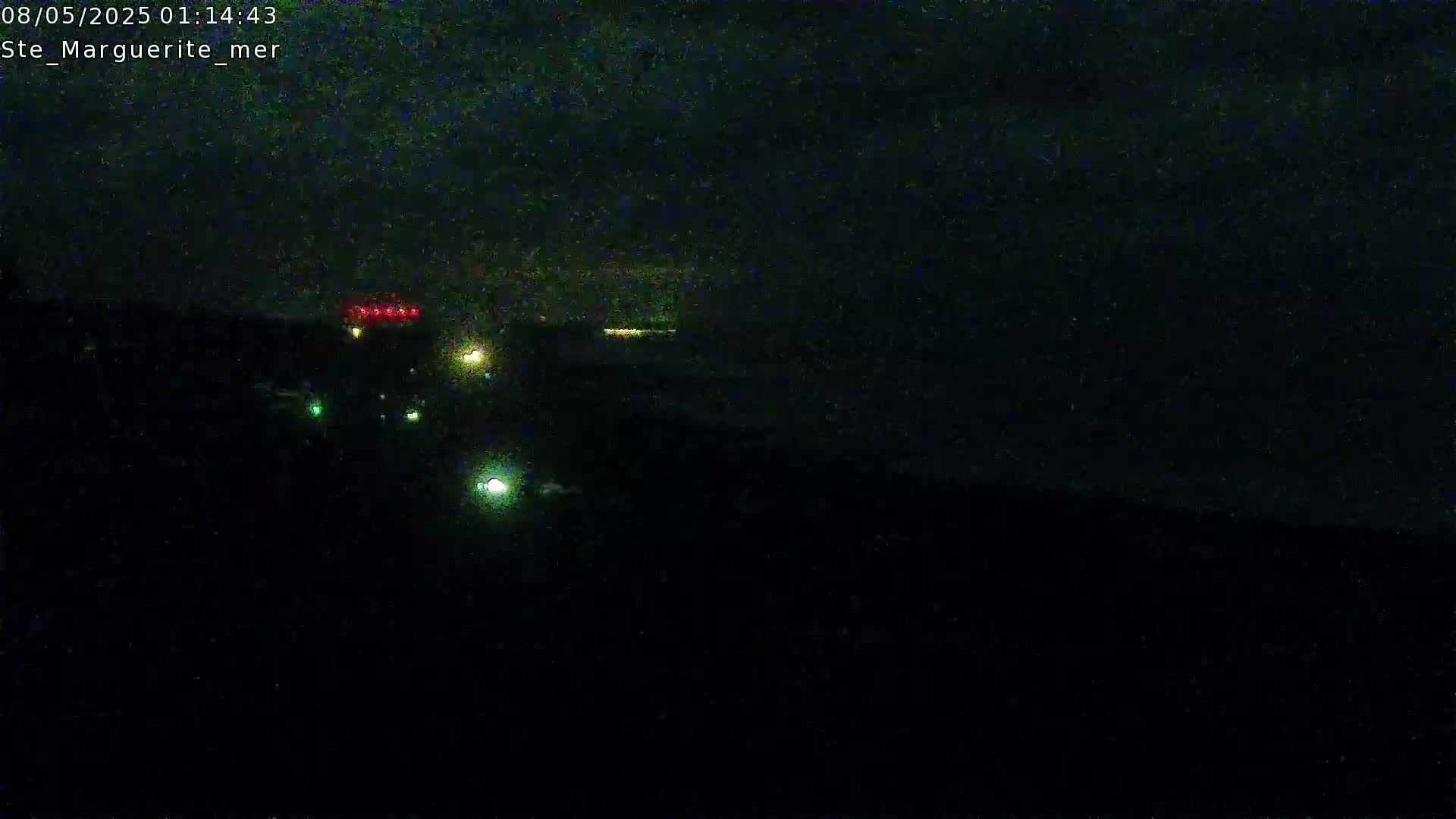 At night, several scattered lights are visible in the distance, possibly from vehicles or buildings.