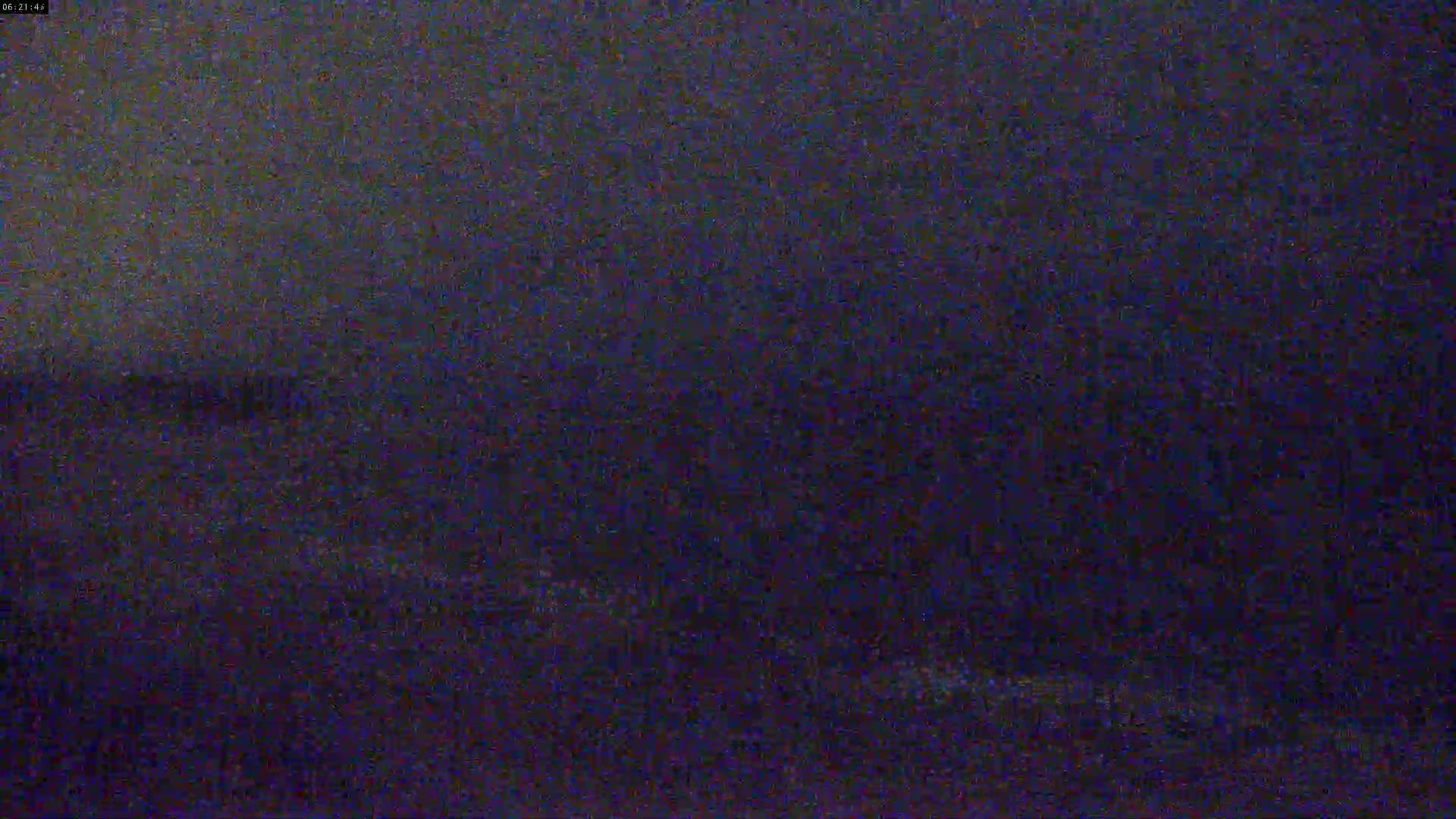 A dark, blurry image shows a seemingly nighttime scene of a body of water under a dark sky.