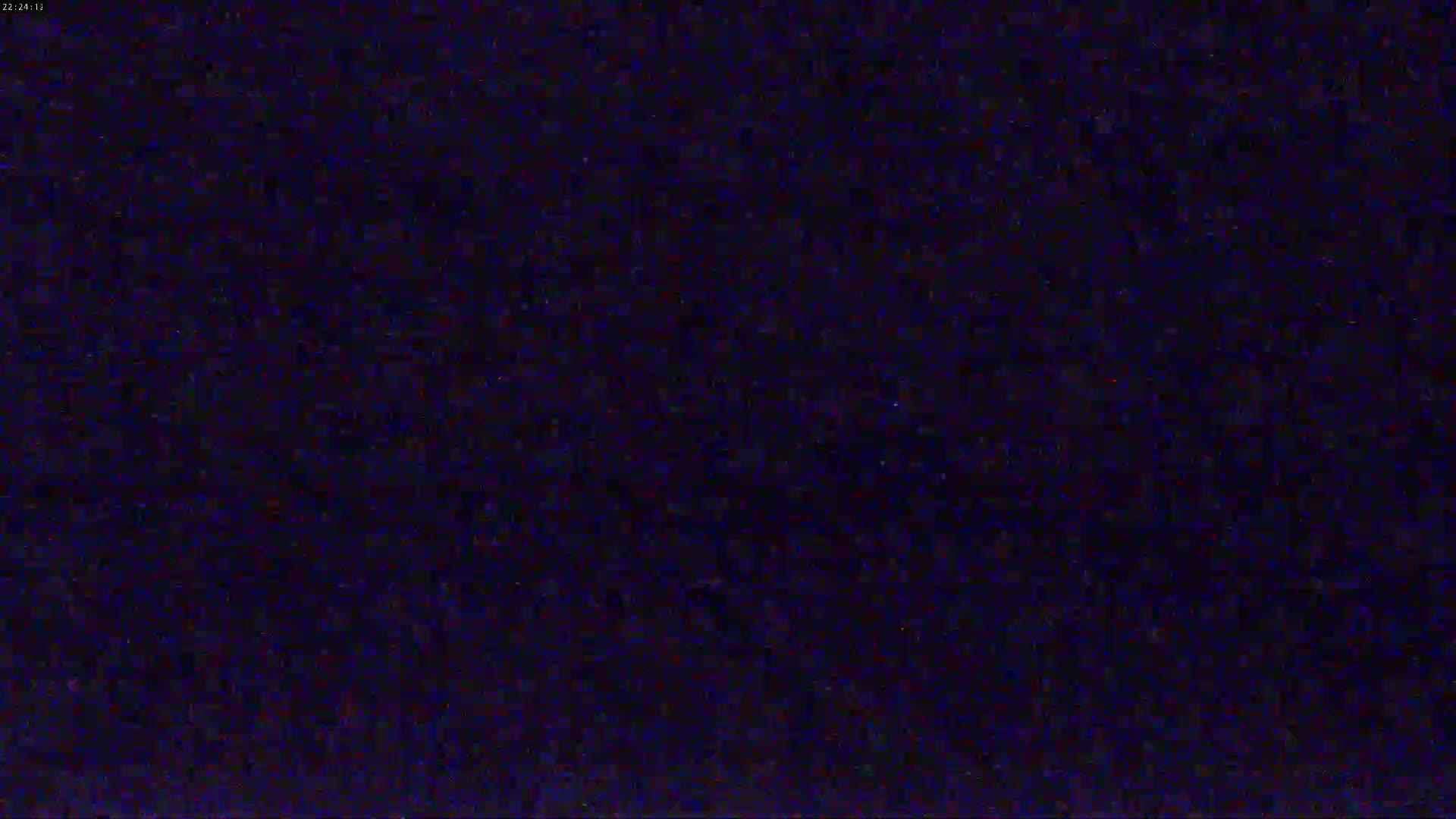 The image shows a dark, grainy screen displaying static.