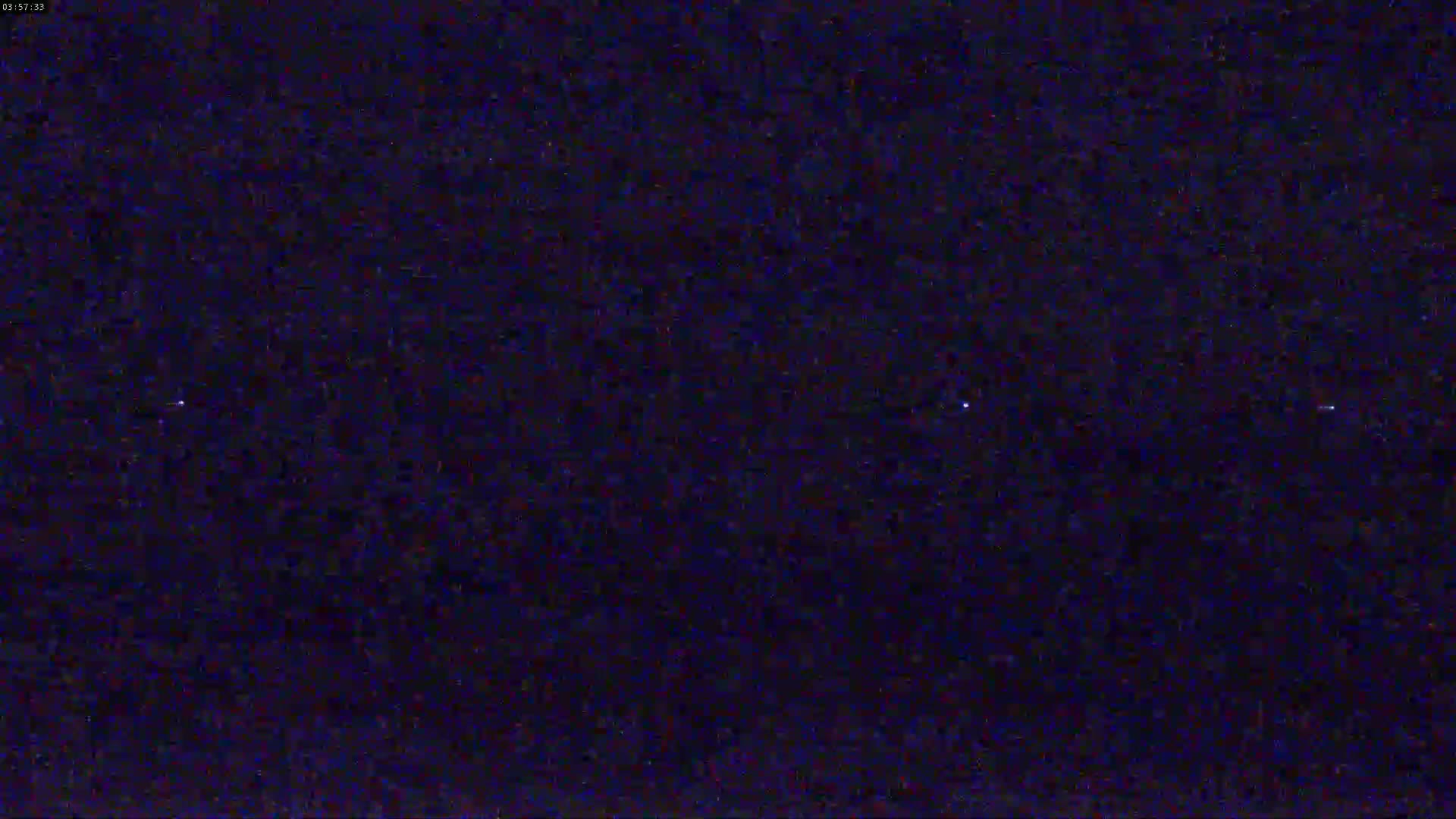A dark nighttime sky shows a few faint stars.