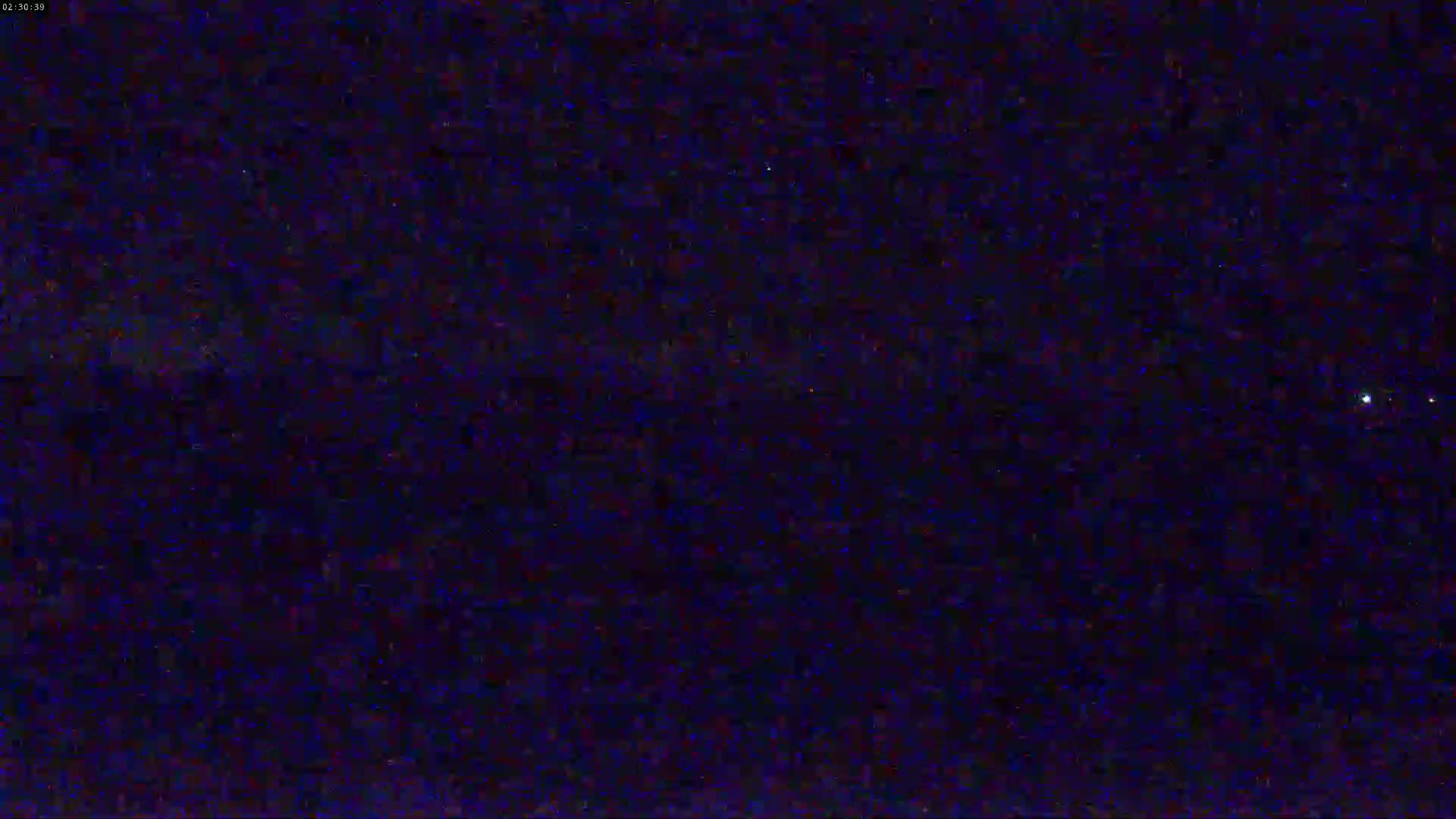 A nighttime view of a dark sky speckled with stars and a bright celestial body.