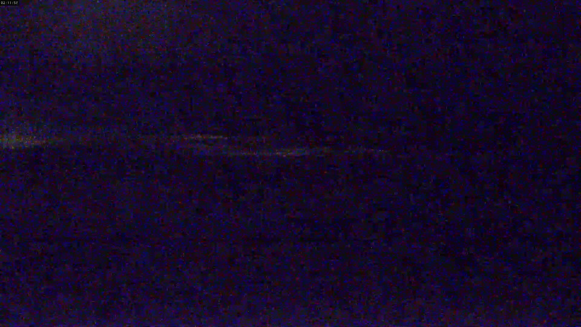 A dark, blurry image shows a faint horizontal line of light across a mostly black background.