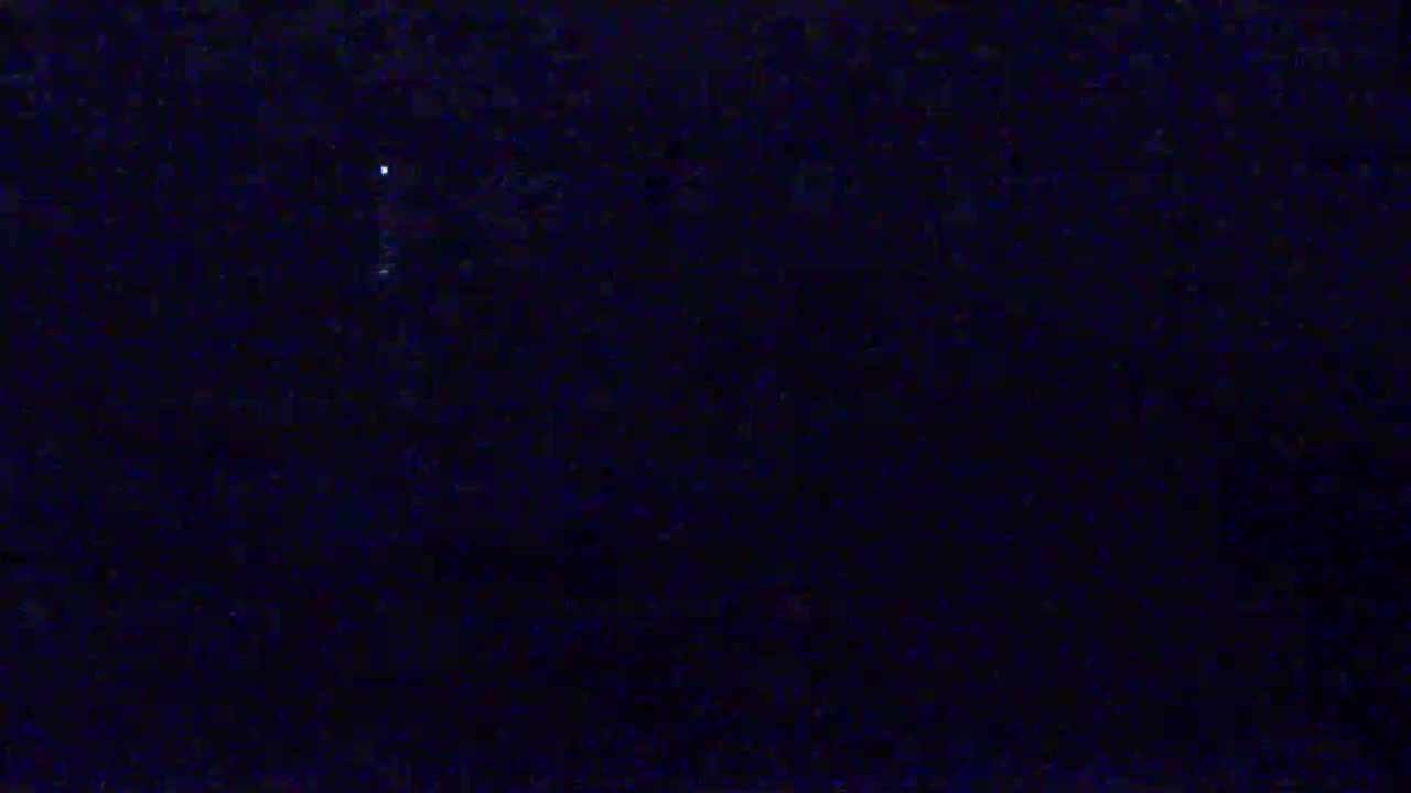 A single, faint light is visible in the dark.