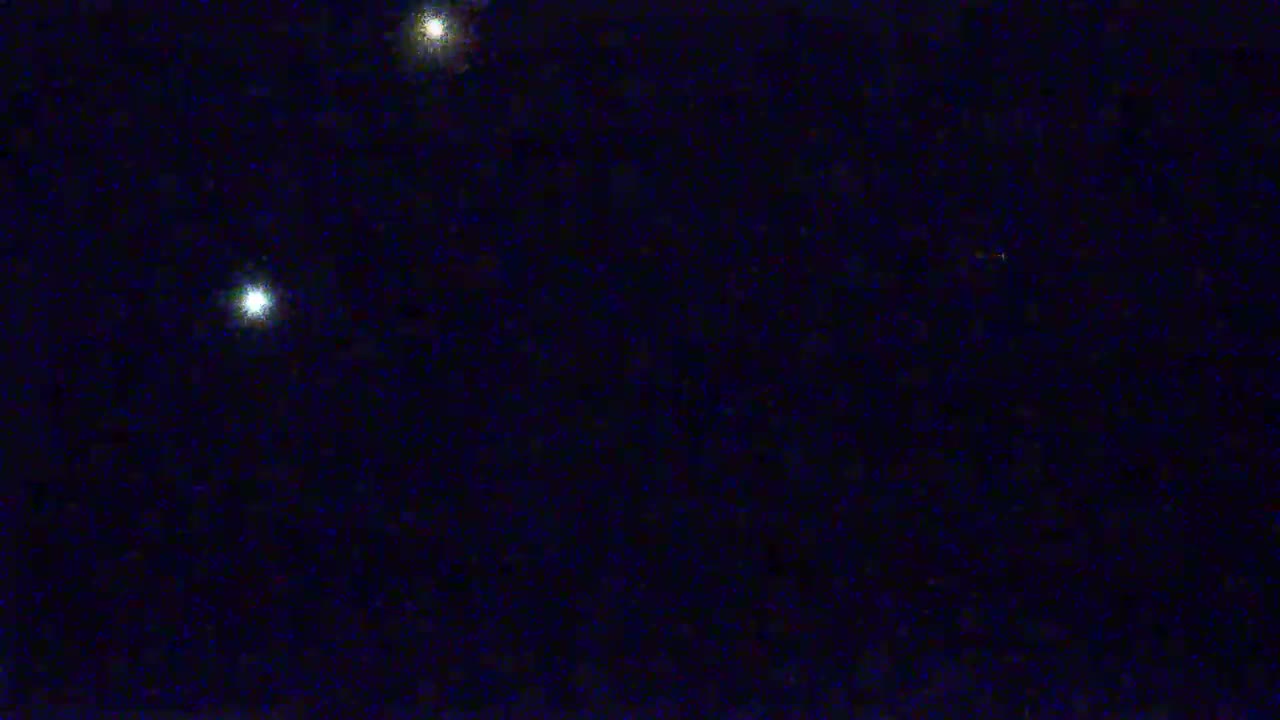 A dark night sky shows three bright stars.