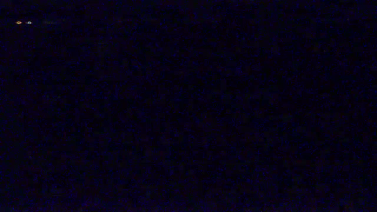 The image shows a dark, grainy texture that resembles static noise.