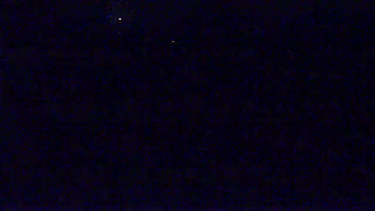 A dark, nighttime sky shows a few faint stars.