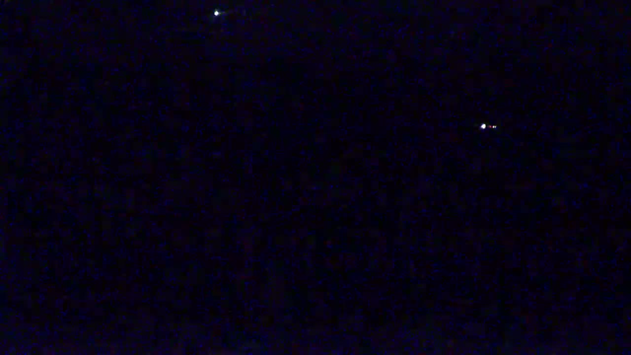A dark night sky shows a few bright stars.