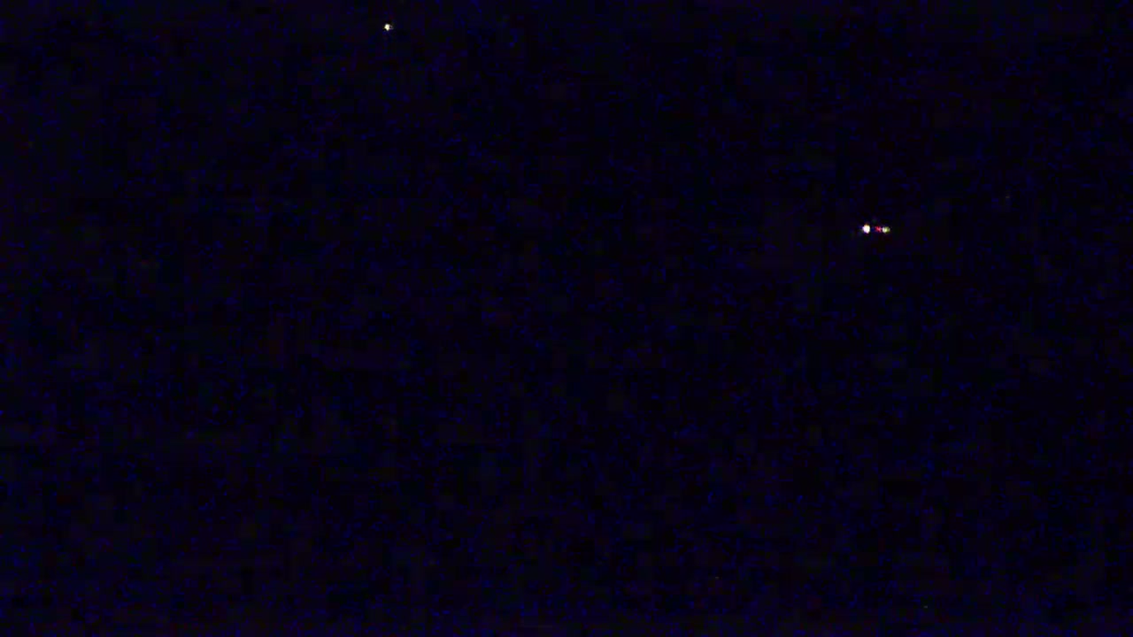 A dark night sky shows a few bright stars.