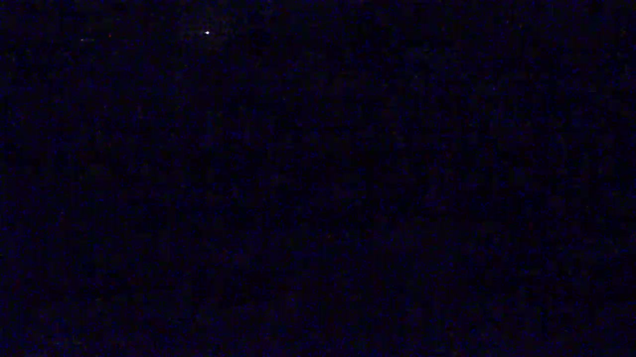 A dark, nighttime sky speckled with numerous faint stars.