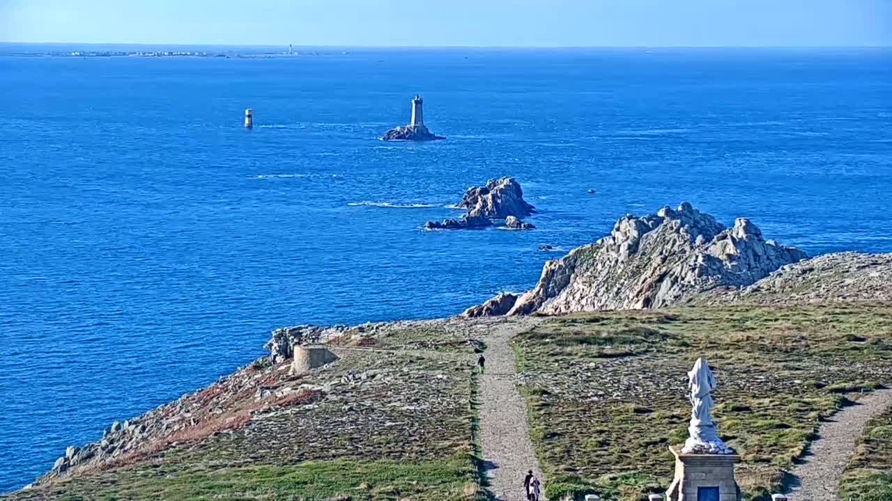 A dark, nighttime scene shows a distant line of lights, possibly a city skyline, against a very dark, possibly overcast sky.