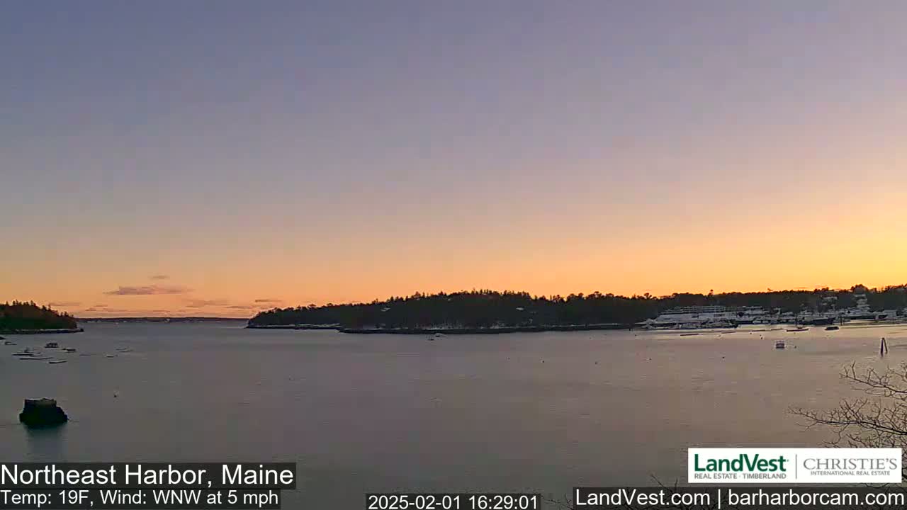 A calm harbor at sunset, with a temperature of 19°F and a west-northwest wind at 5 mph.