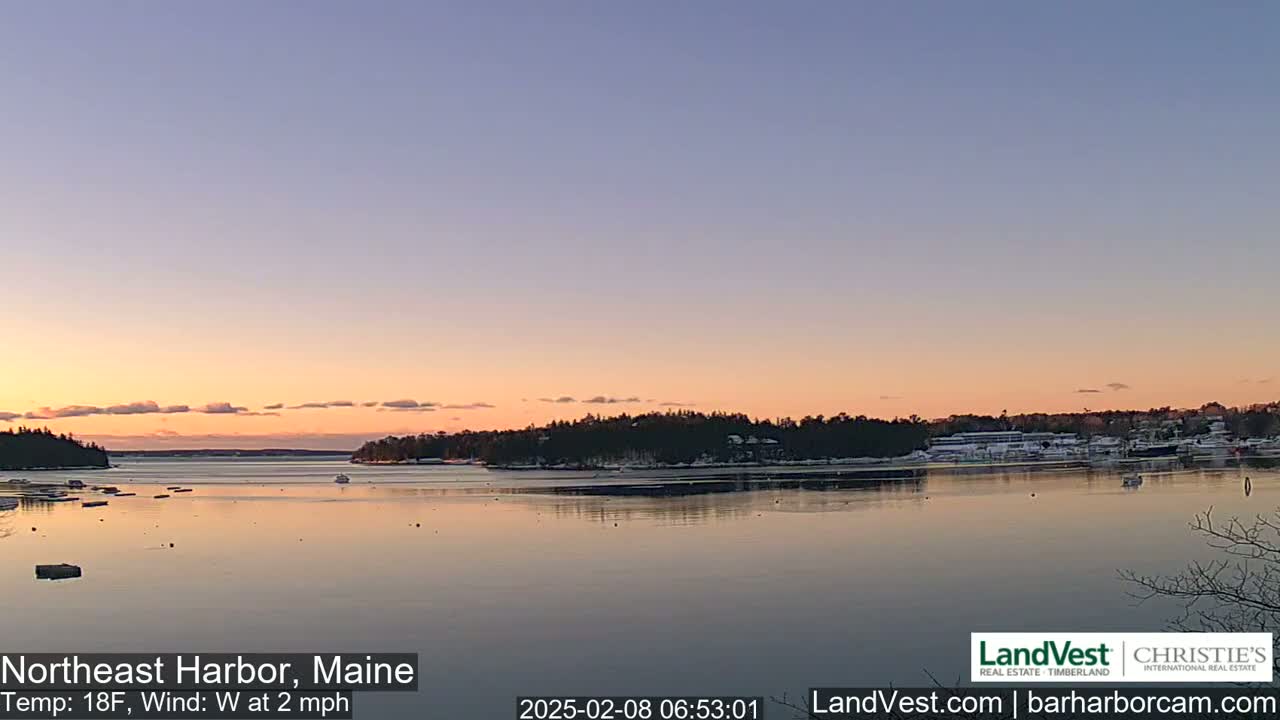 A calm harbor at sunset, with a temperature of 18°F and a westerly wind of 2 mph.