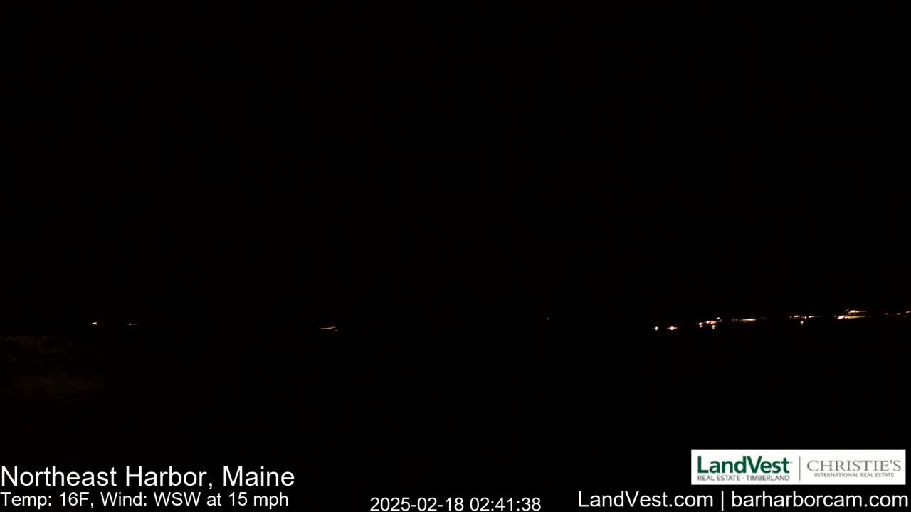 A nighttime, dark view of a dimly lit shoreline with a 16°F temperature and a 15 mph wind blowing from the west-southwest.