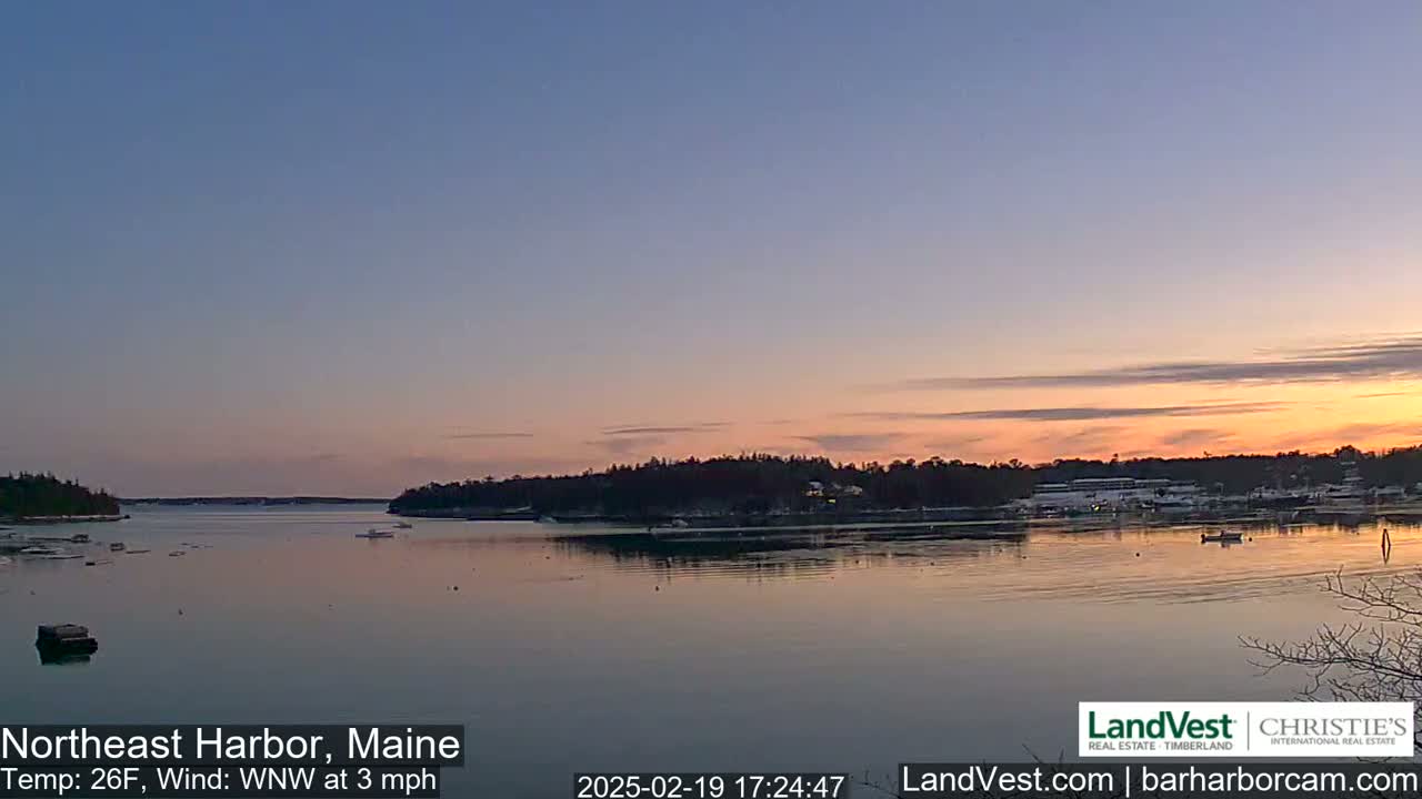 A calm harbor at sunset, with a 26°F temperature and a gentle west-northwest wind.
