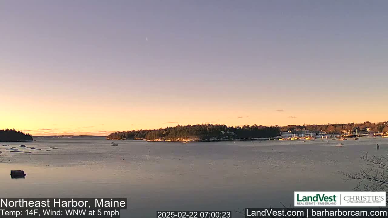A calm harbor at sunset, with a temperature of 14°F and a gentle west-northwest wind.