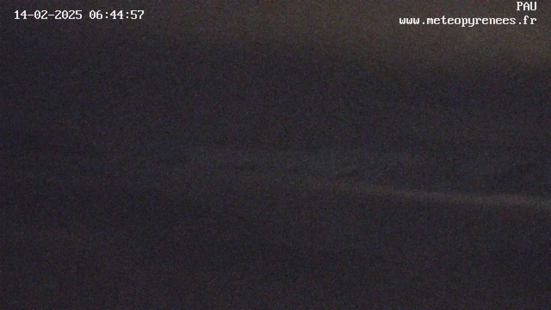 A dark, possibly nighttime, outdoor scene shows a mostly featureless, dark gray landscape.
