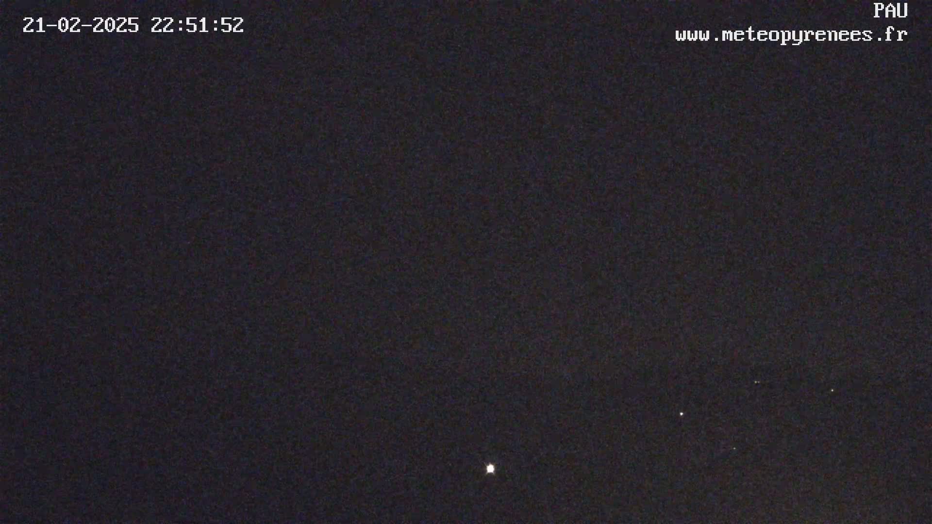A dark night sky with a few faint stars visible.