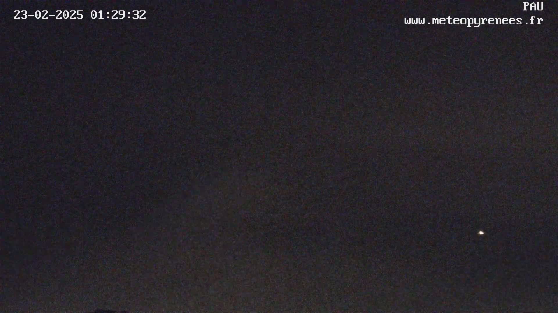 A nighttime image shows a dark sky with a single, bright star visible.
