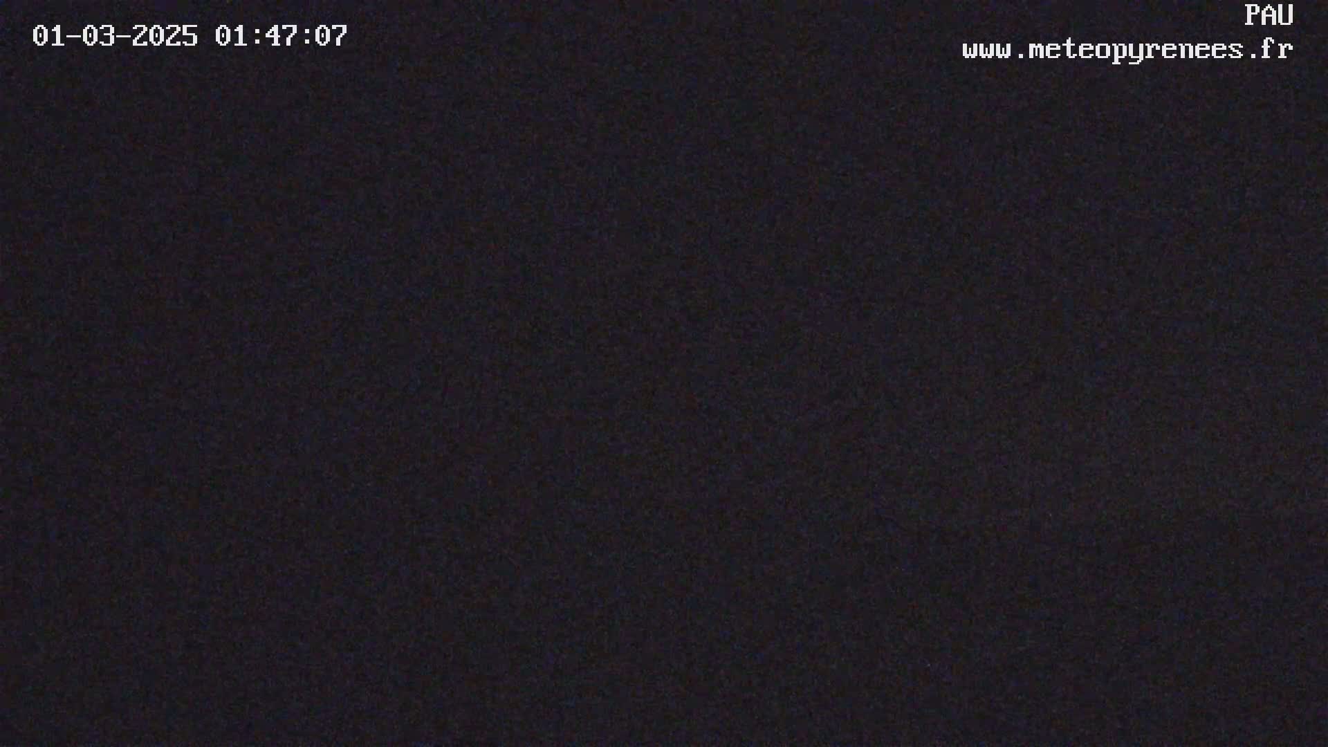 A dark, grainy image shows a nighttime scene with no discernible objects.