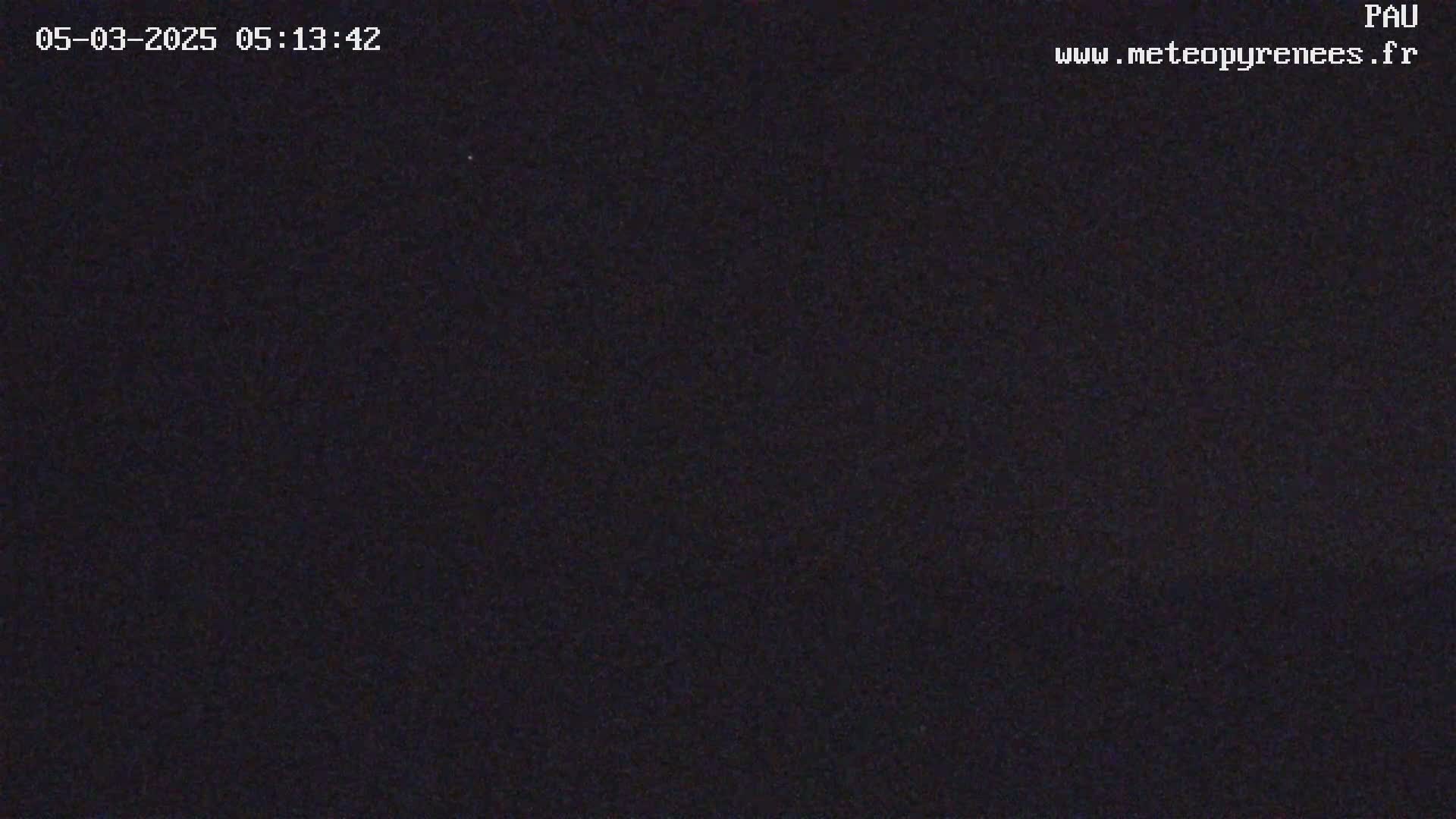 A nighttime image shows a dark, mostly uniform view with slight variations in shading.