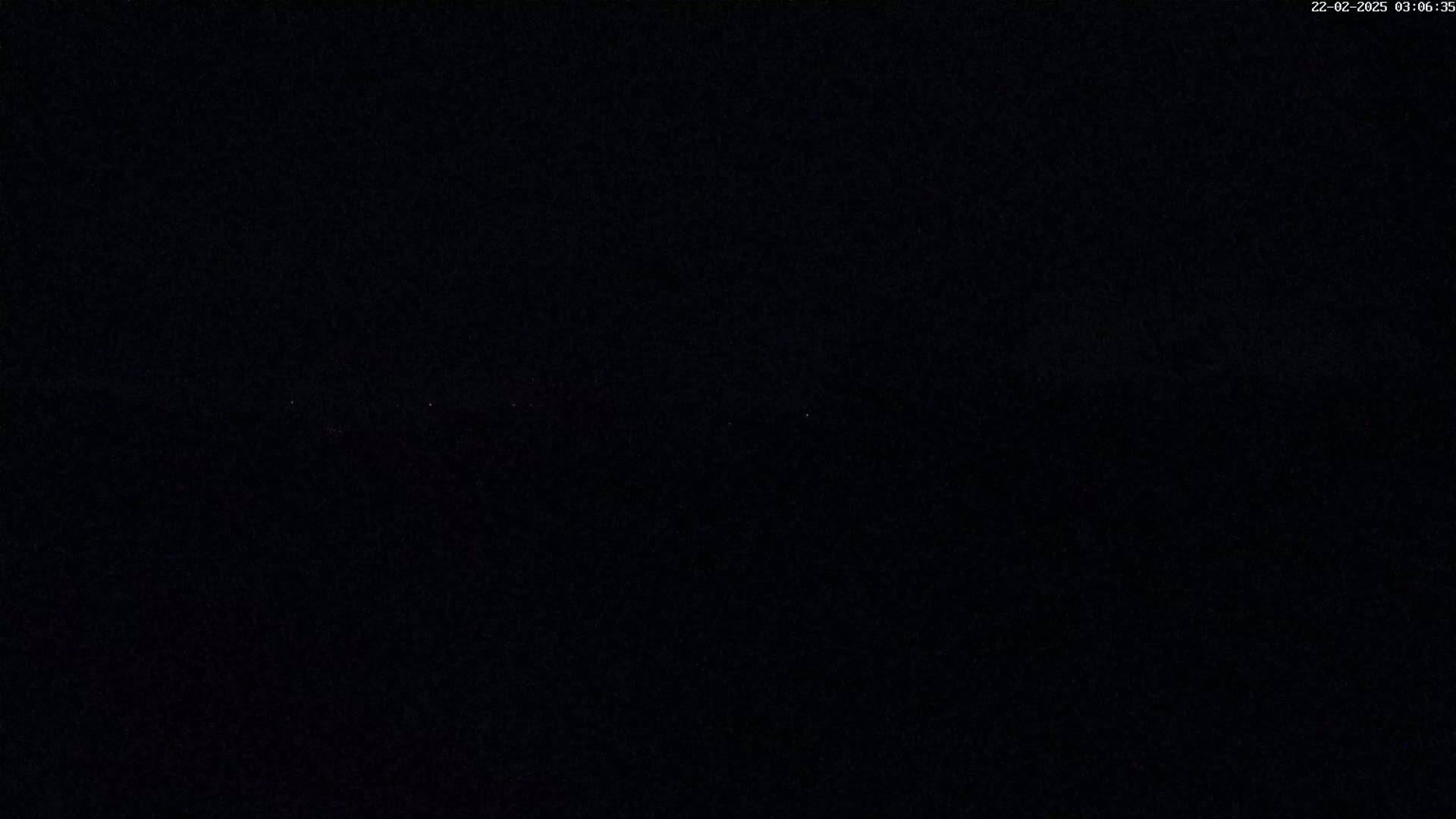 The image shows a completely dark, nighttime scene.