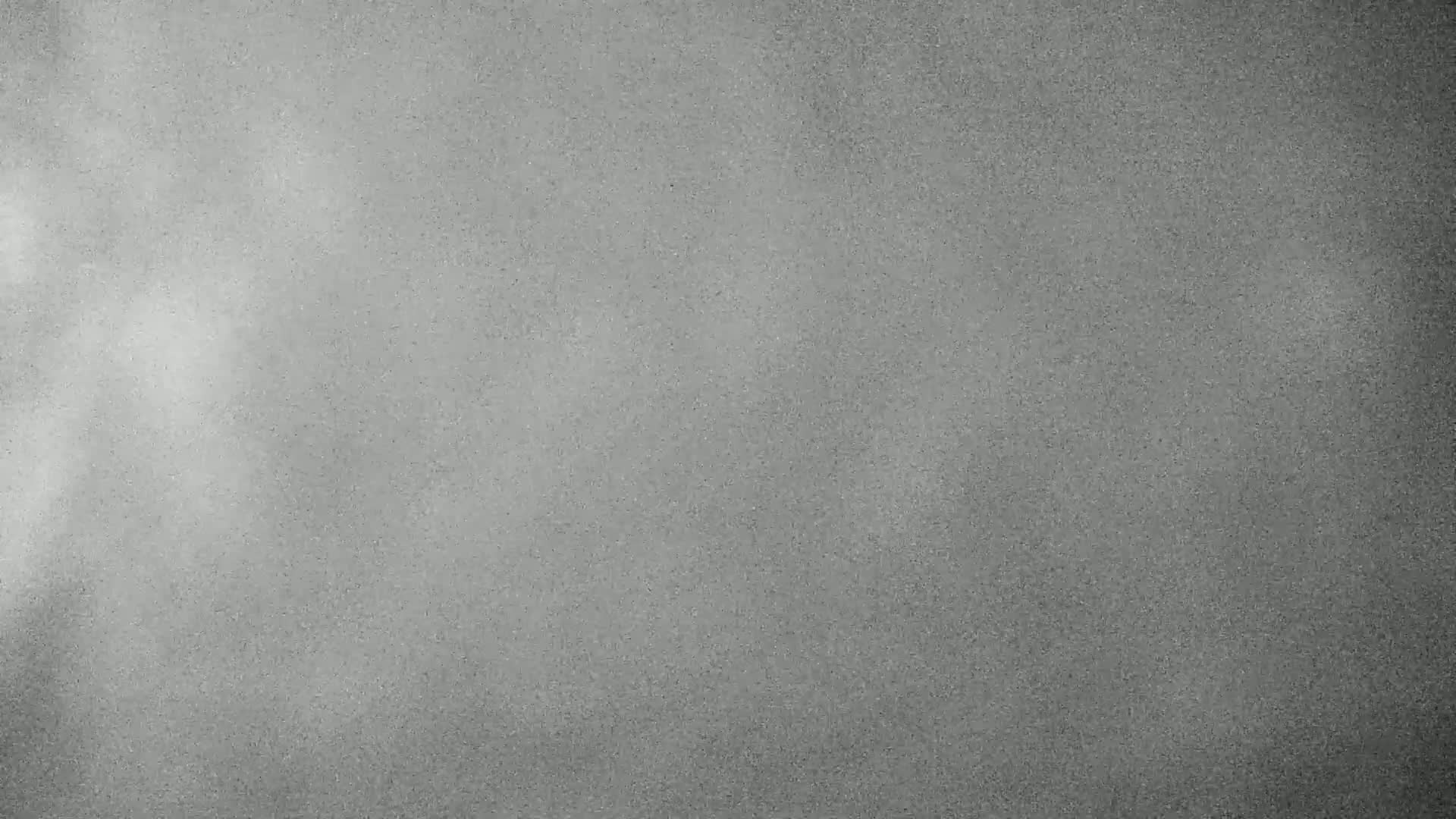 A gray textured surface is shown with lighter gray shading in the upper left corner.