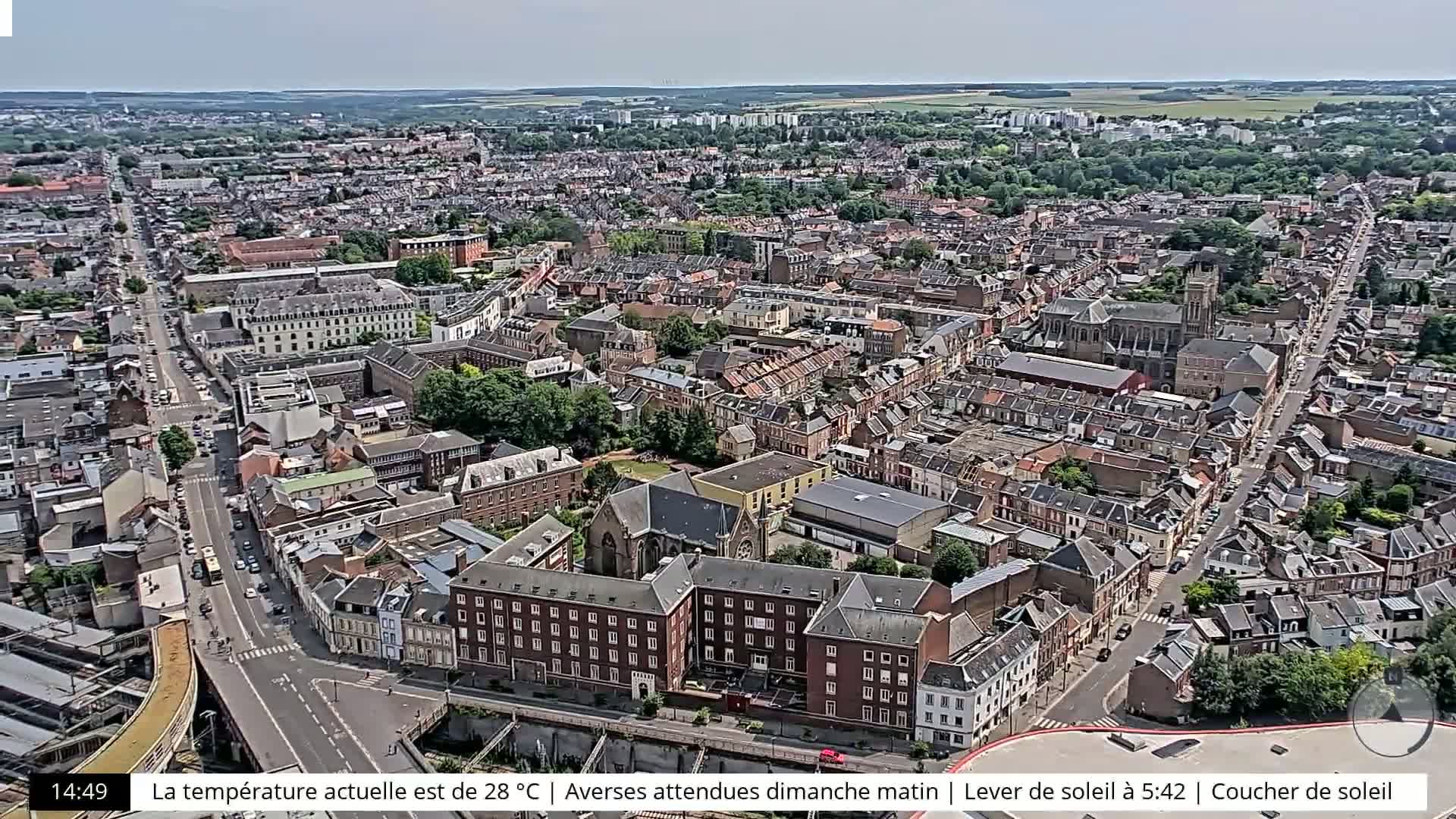 An aerial view shows a densely populated city on a clear day.
