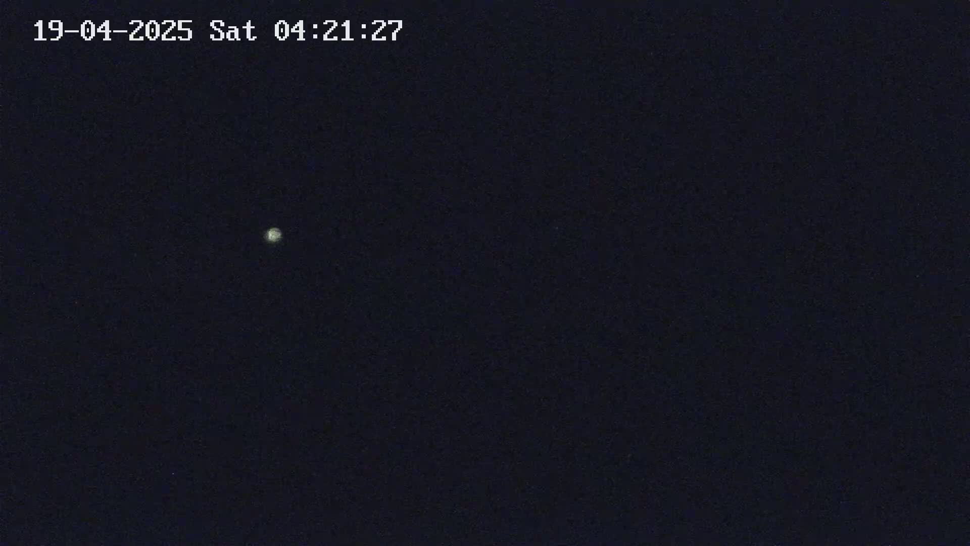 A single, bright celestial body is visible in a dark night sky.