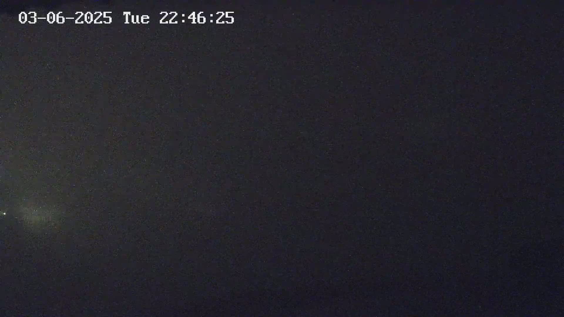 A dark, night sky is visible, speckled with numerous stars.