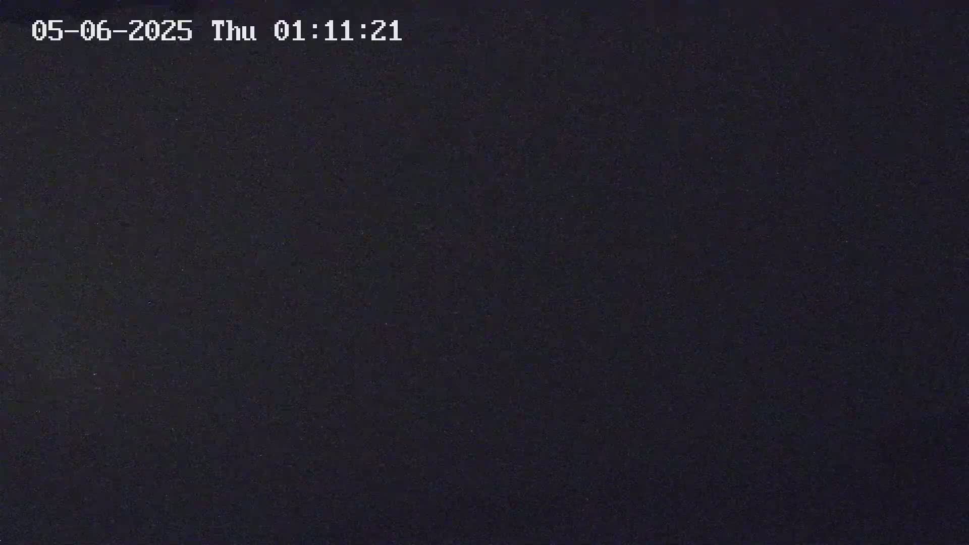 The image is a completely dark, grainy, black screen.