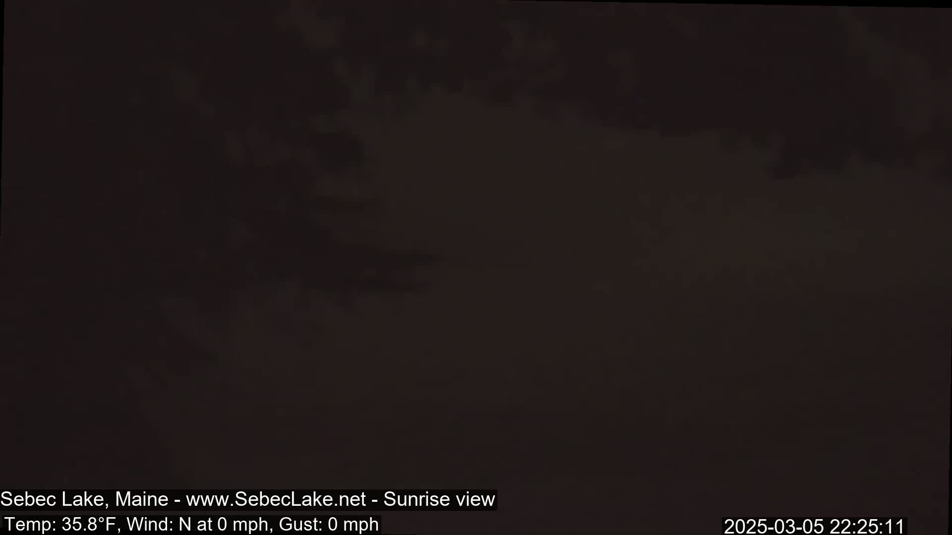 A dark, mostly featureless outdoor scene shows a pre-dawn or nighttime sky.