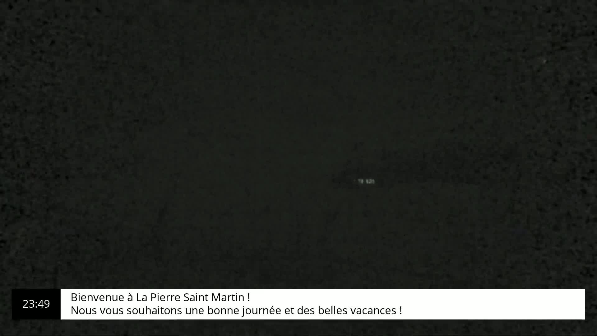 A dark, grainy image shows a mostly black screen.
