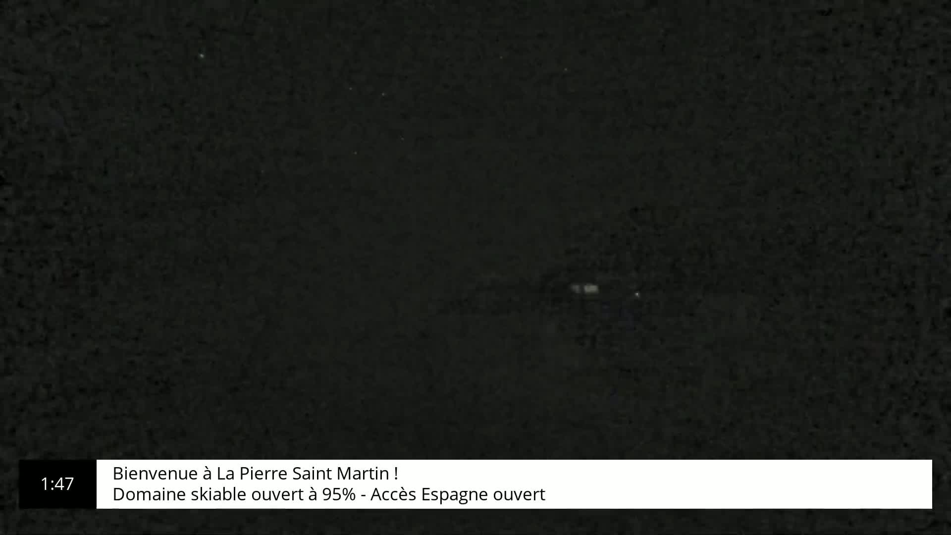 A very dark, possibly nighttime image of a snowy landscape is shown.