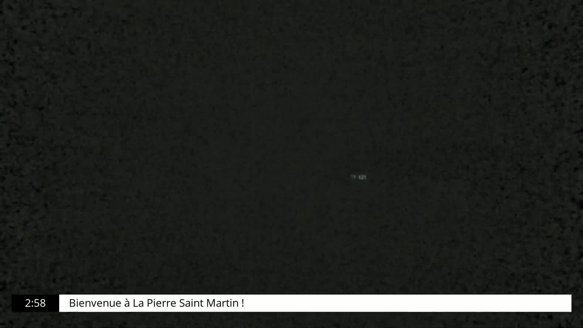 A dark, grainy image shows a mostly black screen.