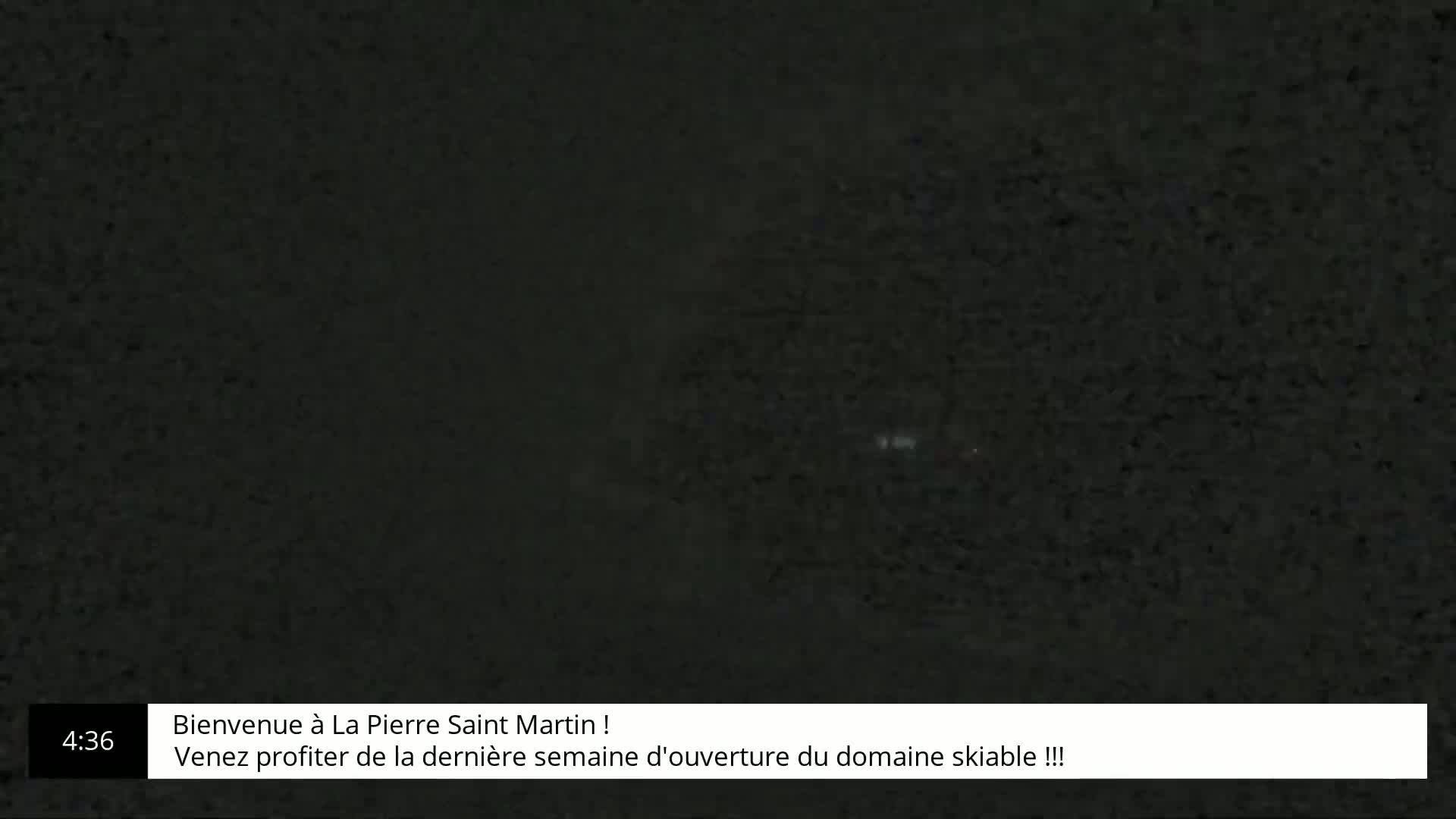 A dark, grainy image shows a blurry, indistinct scene at night.
